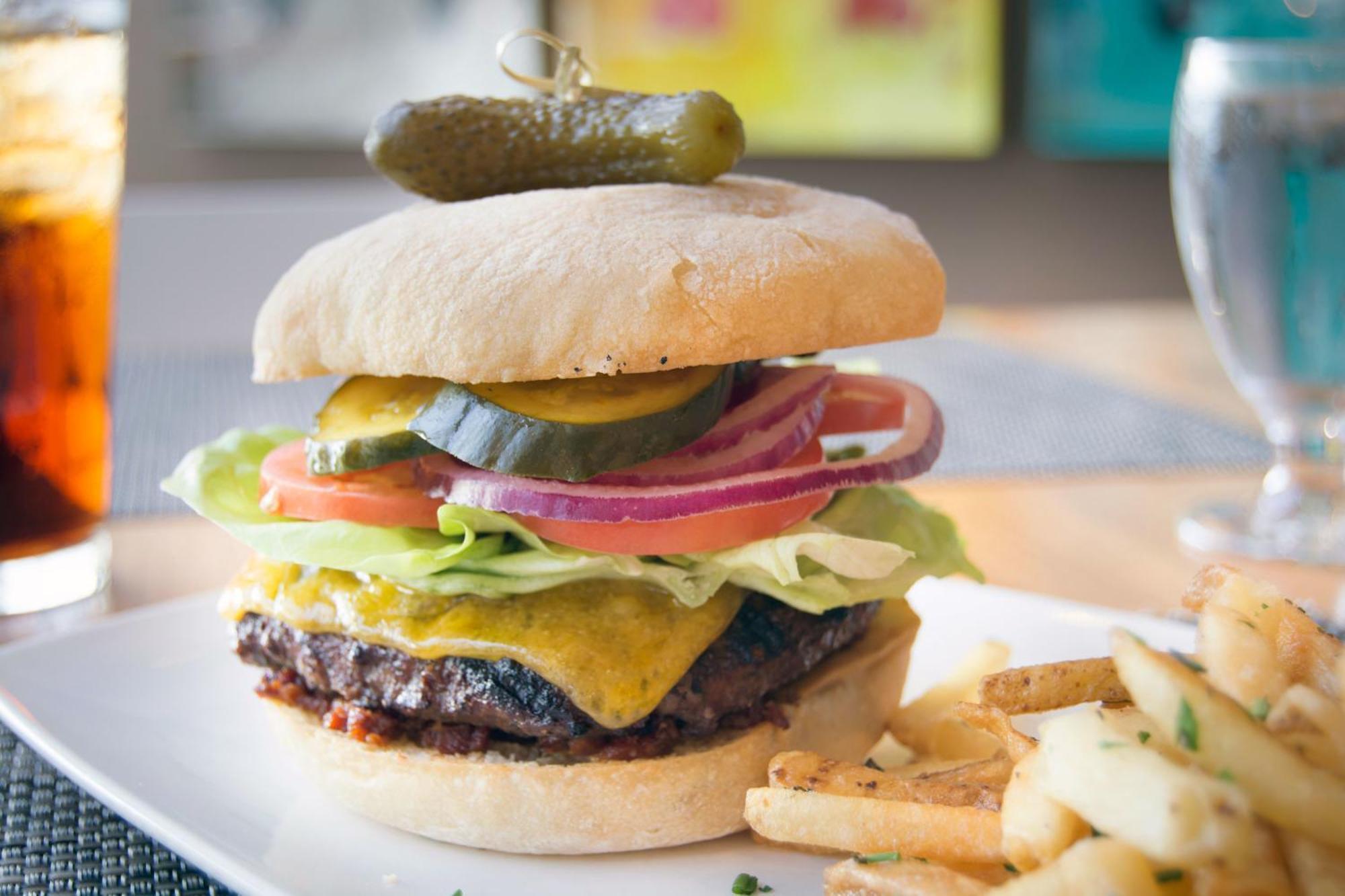 Hotel Murano Tacoma Zewnętrze zdjęcie A cheeseburger with lettuce, tomato, onion, and pickle
